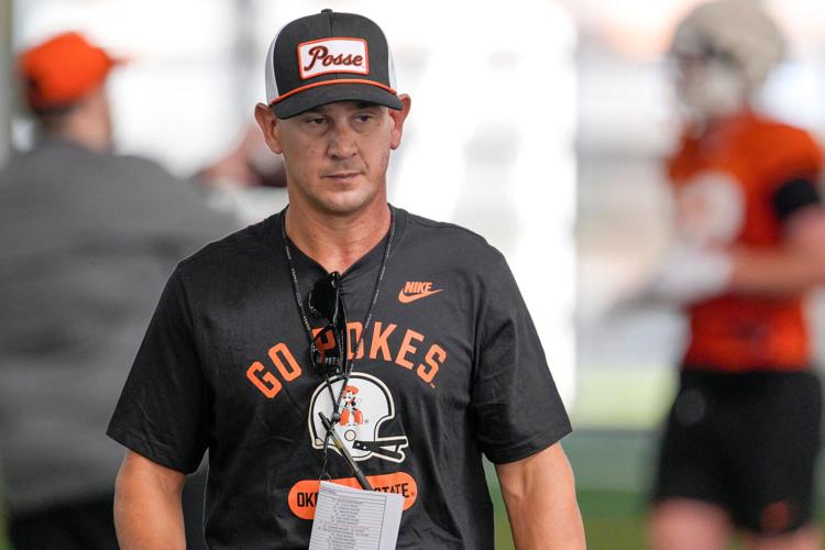 Oklahoma State head coach Eric Morris runs drills during a morning football practice at OSU in Stillwater, Okla., on Wednesday,