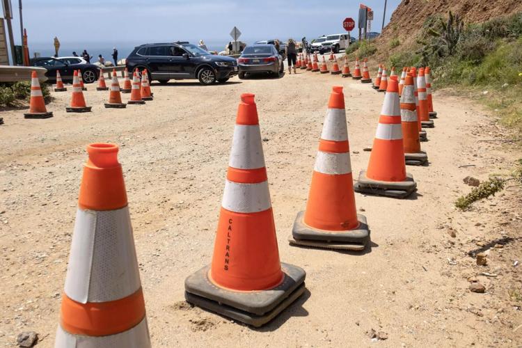 Safety cones prevent parking along Coast Road near the Bixby Bridge.