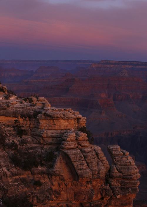 The colors of dawn begin to paint the age-old rock formations of the Grand Canyon along the South Rim near Mather Point on March 11, 2015. National Parks are taking a "phased approach" to reopening.