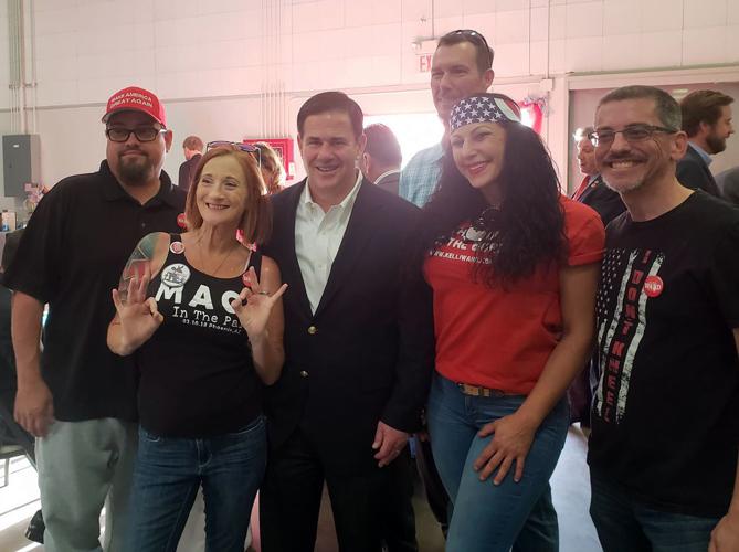 Ducey denounces controversial group days after posing for photo with members