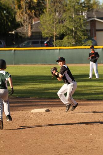 A photo of Tommy Troy playing baseball as a child.