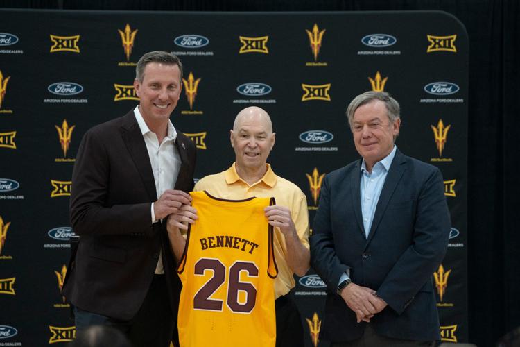 Randy Bennett (center) gets an ASU jersey from Graham Rossini (left, athletic director) and Michael Crow (right, President) during a press conference at the Weatherup Center, in Tempe on May 7, 2026.