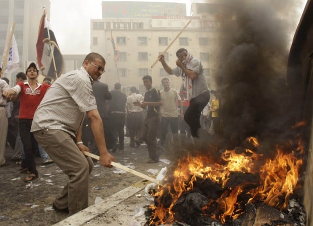 Gov't-backed men with clubs bash democracy demonstrators in Iraq   
