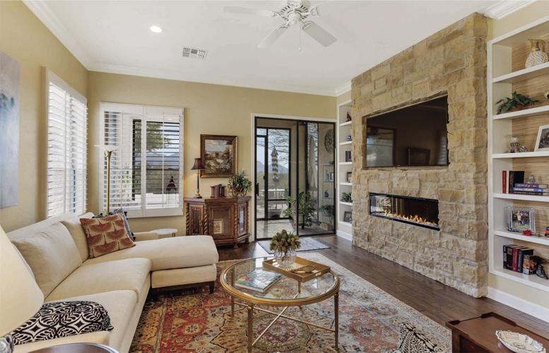 A-limestone-veneer-feature-wall-with-LED-color-changing-fireplace-graces-the-living-room.jpg