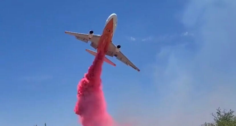 Air Tanker drops retardant onto the Adams Robles Complex, located east of Benson