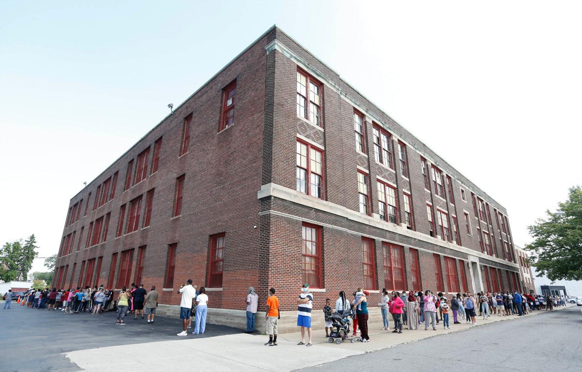 Parents and students wait in long lines for tech service