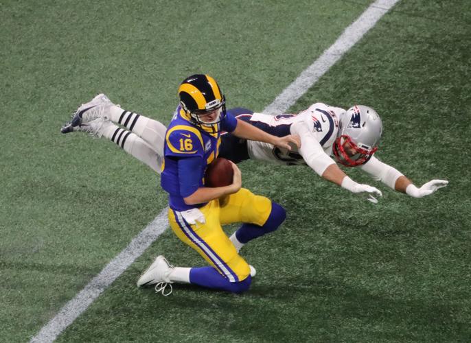 Los Angeles Rams quarterback Jared Goff (16) goes down for a sack by New England Patriots linebacker Kyle Van Noy (53) in the second quarter during Super Bowl LIII on Sunday, Feb. 3, 2019, at Mercedes-Benz Stadium in Atlanta. The Patriots won, 13-3.