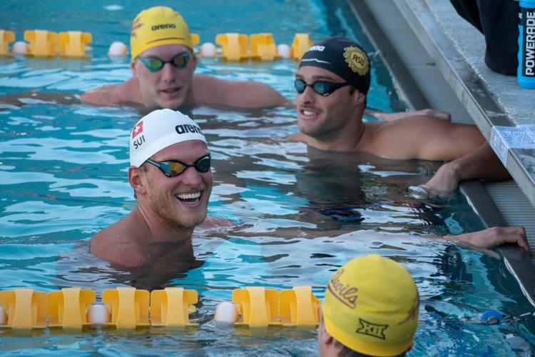 Grant House (left front) talks with teammates during swimming practice at the Mona Plummer Aquatic Center, in Tempe, Arizona, on May 8, 2026.