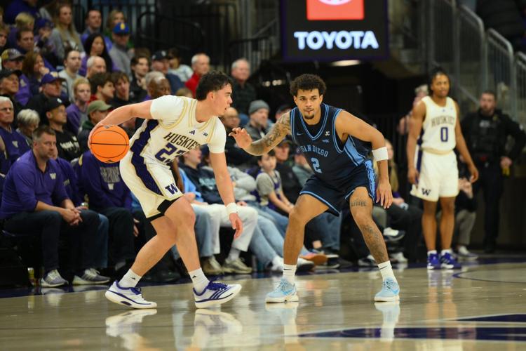 Dec 22, 2025; Seattle, Washington, USA; San Diego Toreros guard Adrian McIntyre (2) guards Washington Huskies guard JJ Mandaquit (23) during the second half at Alaska Airlines Arena at Hec Edmundson Pavilion. Mandatory Credit: Steven Bisig-Imagn Images