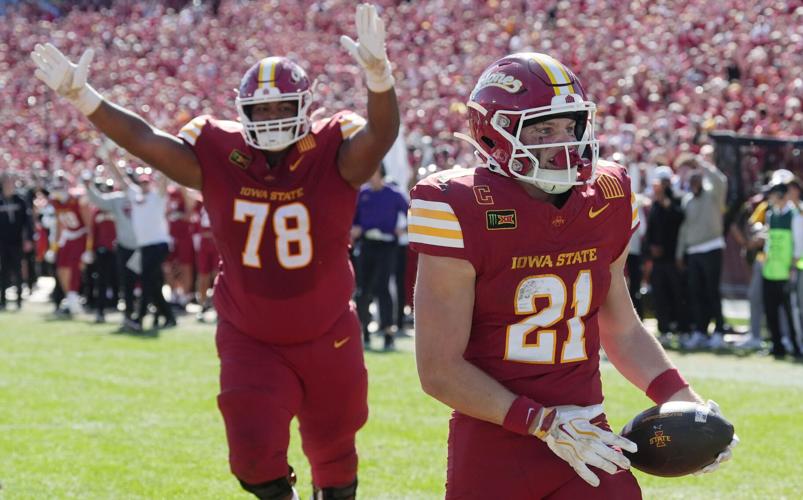 Iowa State running back Aiden Flora (21) scores the game-winning touchdown against West Virginia during the fourth quarter of a