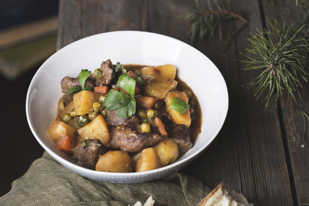 traditional irish beef and guinness beer stew with carrots, potatoes and green peas
