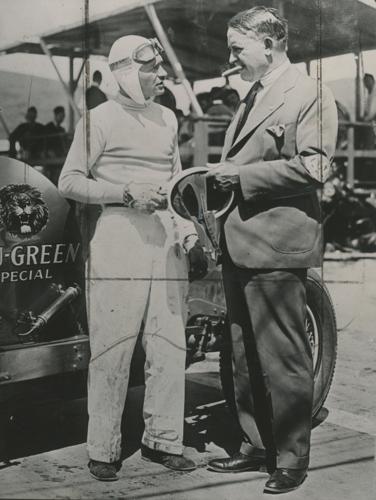 (From left) Three time Indy 500 winner, Wilber Shaw holds an early racing helmet while chatting with Barney Oldfield “The Speed King,” at the Legion Ascot Speedway in California. Shaw used his experience working at Firestone to help develop synthetic rubber tires, The “Channel Tread" tire, and self sealing inner tires to prevent blowouts. Oldfield, a safety advocate wore a safety harness long before it was standard and was the first to do a 100 mph lap at the Indianapolis Motor Speedway.