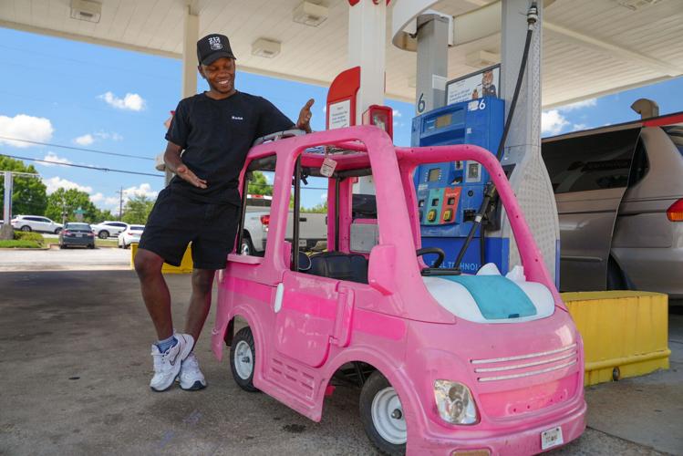 Mali Hightower poses with a pink Power Wheels Barbie Dream Camper outside a gas station in Ellenwood (copy)
