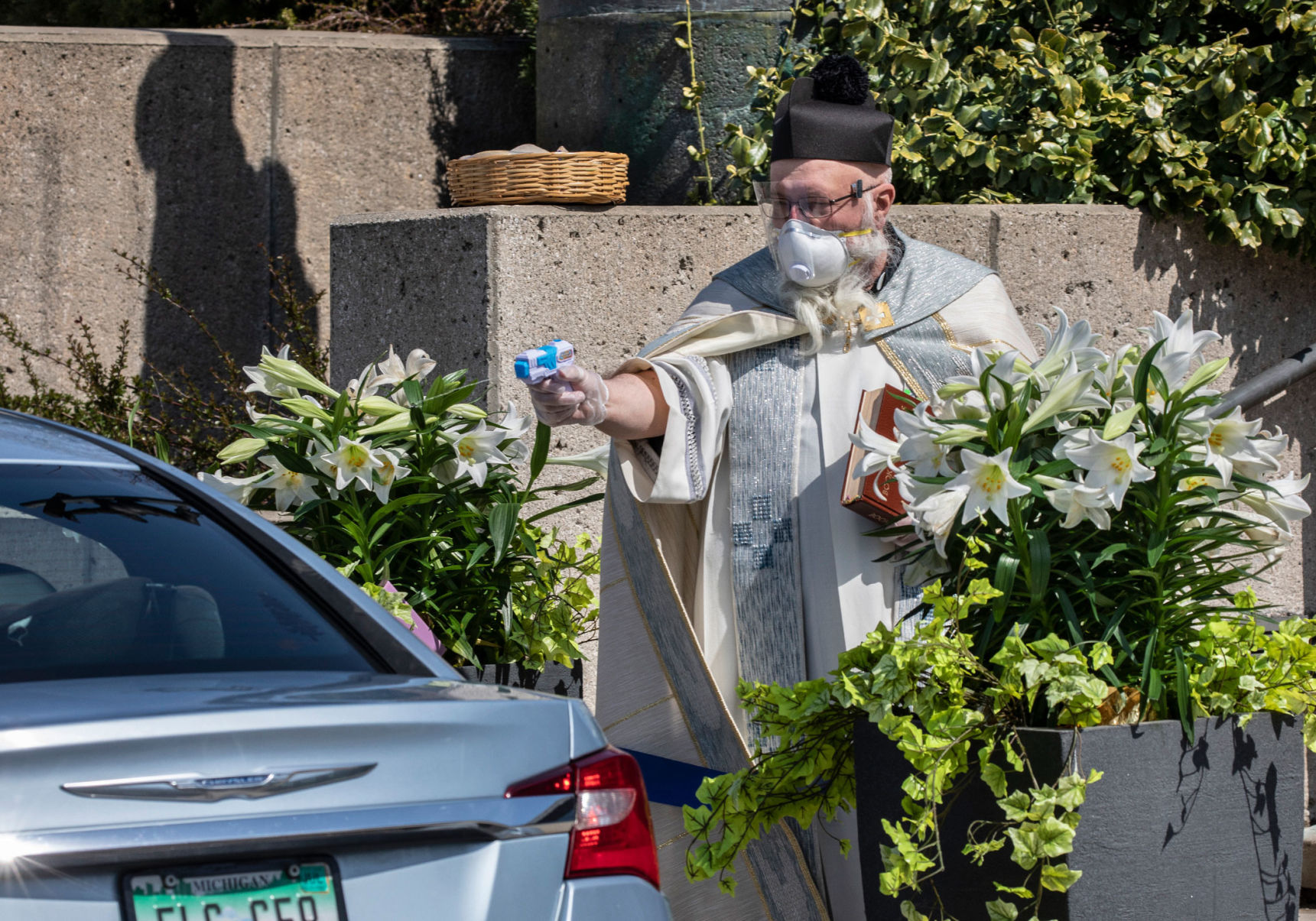 A priest fired holy water through a squirt gun at his congregants. Weeks later, he's gone viral