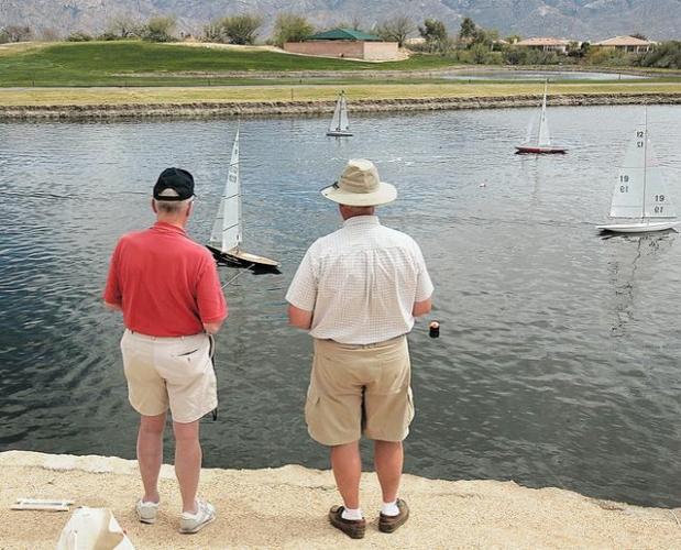 Sailboats race across a pond  