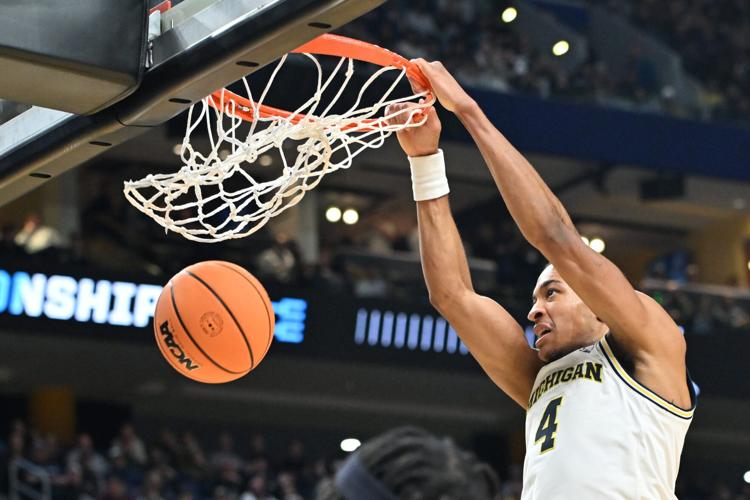 Mar 19, 2026; Buffalo, NY, USA; Michigan Wolverines guard Nimari Burnett (4) dunks the ball against the Howard Bison during the second half of a first round game of the men's 2026 NCAA Tournament at Keybank Center. Mandatory Credit: Mark Konezny-Imagn Imag