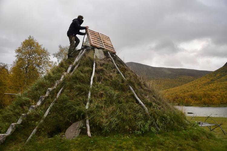 Mikael Vinka stands on top of a traditional goathie home at his Sami Ecolodge near Ammarnas, Sweden.