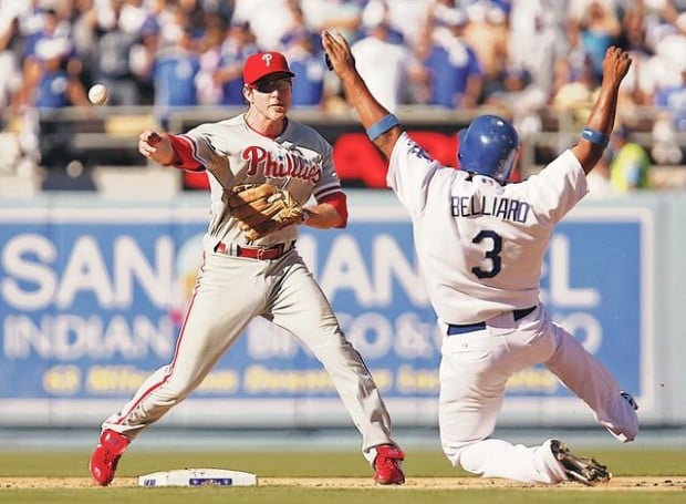 Steve Sax of the Los Angeles Dodgers relays a double play throw to