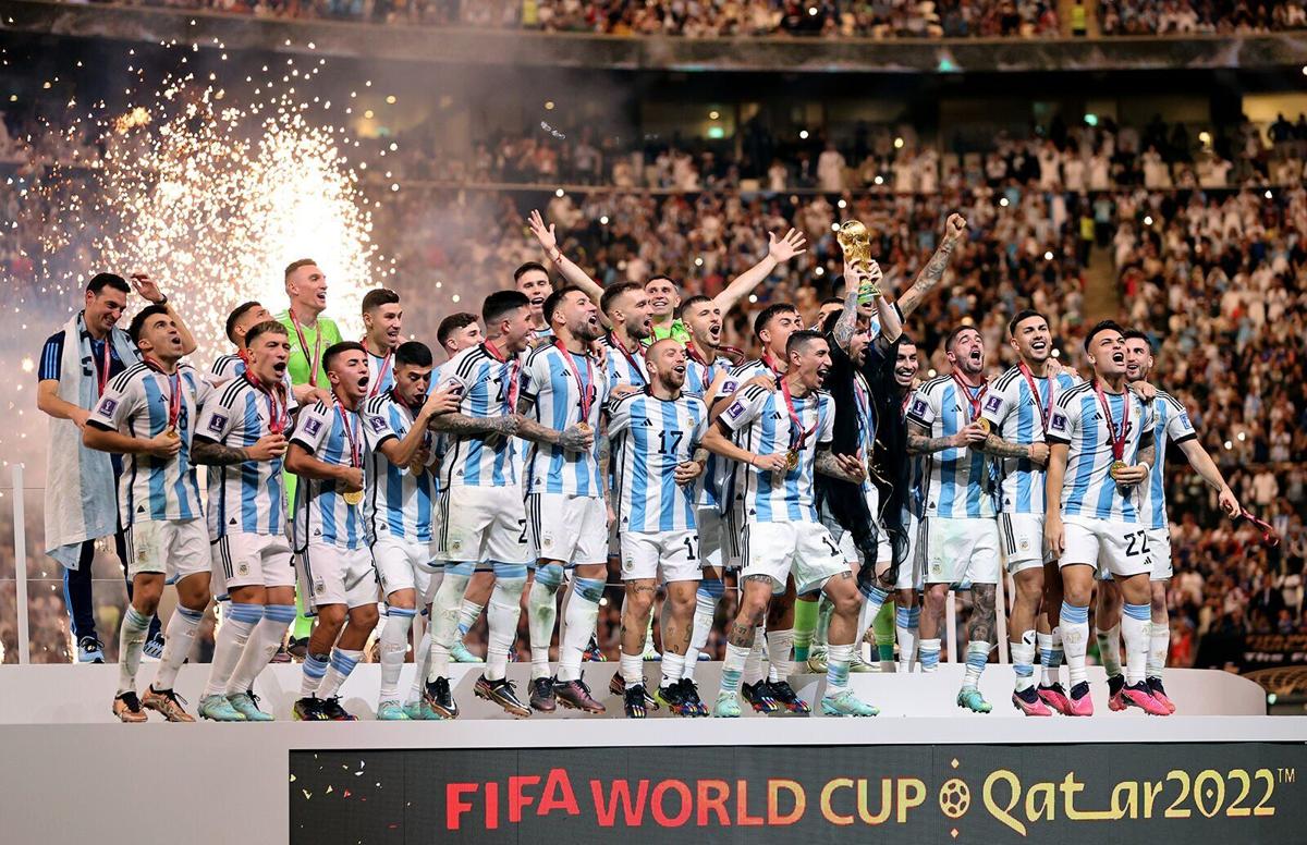 Lionel Messi of Argentina lifts the FIFA World Cup Qatar 2022 Winner's Trophy alongside his team mates during the FIFA World Cup Qatar 2022 Final match between Argentina and France at Lusail Stadium on Dec. 18, 2022, in Lusail City, Qatar.