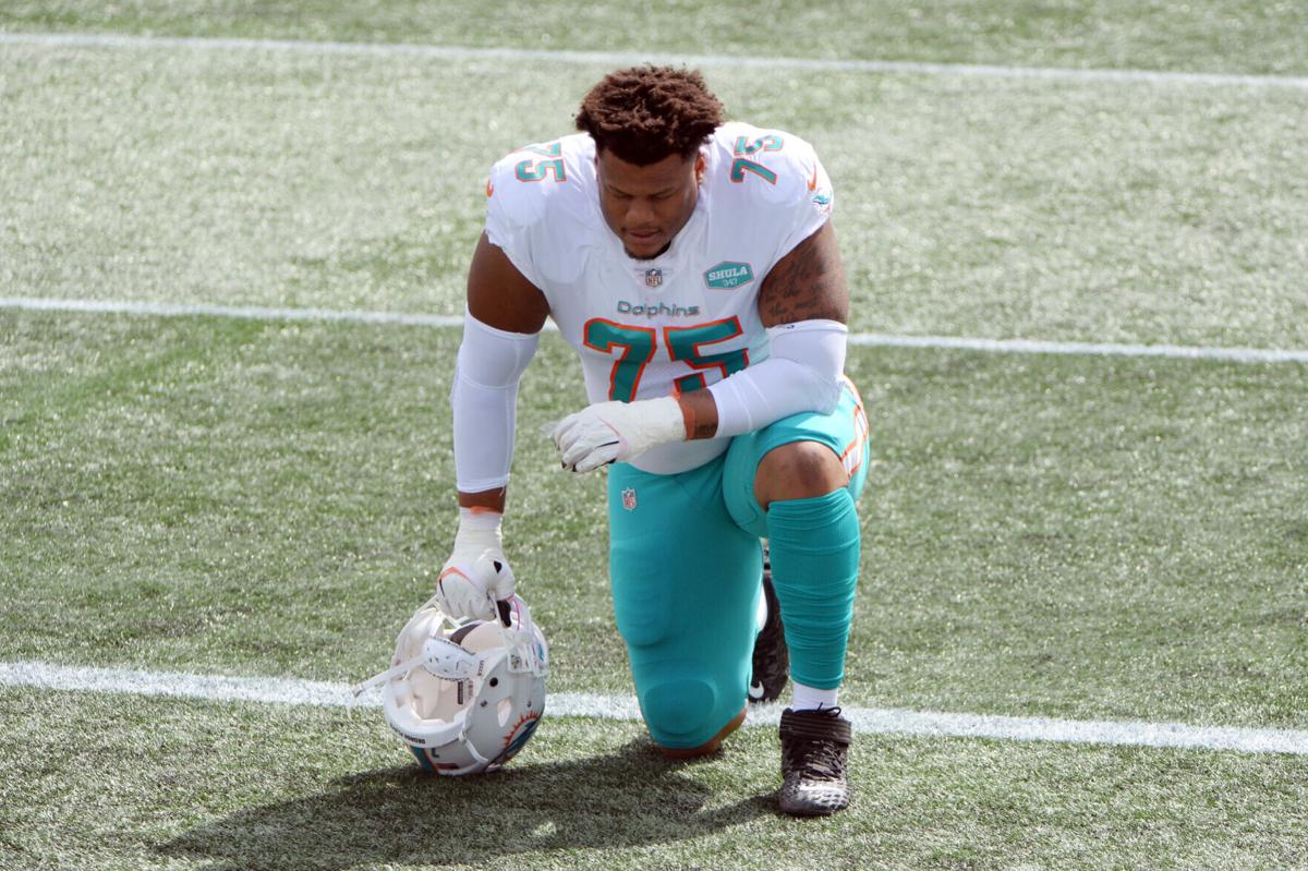 Ereck Flowers #75 of the Miami Dolphins kneels before the game against the New England Patriots at Gillette Stadium on September 13, 2020, in Foxborough, MA.