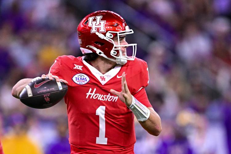 Dec 27, 2025; Houston, TX, USA; Houston Cougars quarterback Conner Weigman (1) looks to pass the ball during the first half against the Louisiana State Tigers at NRG Stadium. Mandatory Credit: Maria Lysaker-Imagn Images