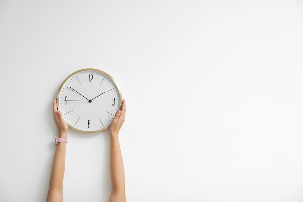 Woman holding clock