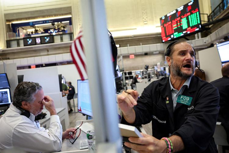 Traders work on the floor of the NYSE in New York