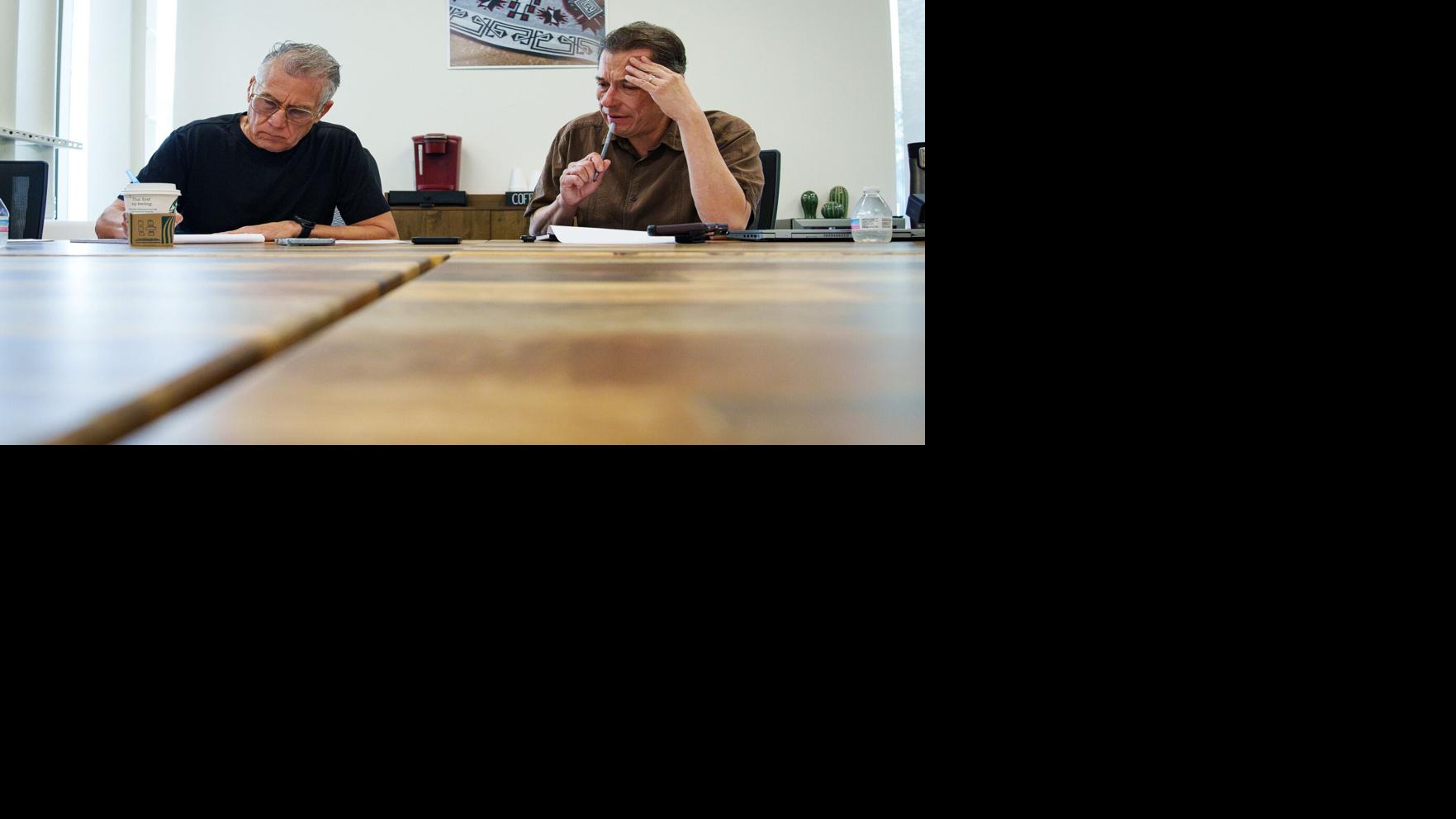 Reporters Daniel Gonzalez and Richard Ruelas speak to Diego Gonzalez-Rosales on the phone in the Arizona Republic newsroom on Aug. 10, 2026, in Phoenix, Ariz.
