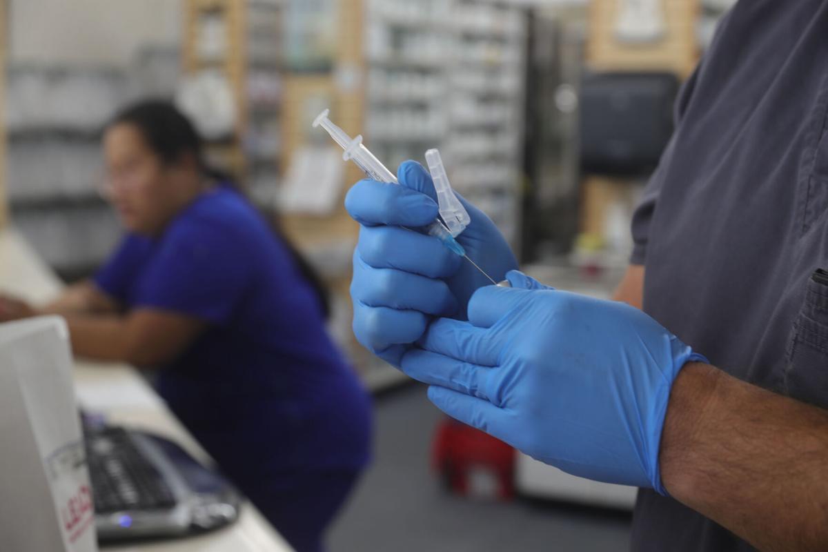 Pharmacist Craig Rudzinski prepares a vaccine shot (copy)