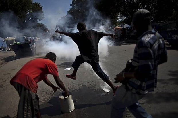 Cars attacked as cholera riots spread in Haiti's capital   