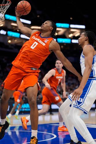 Mar 13, 2026; Charlotte, NC, USA; Clemson Tigers forward RJ Godfrey (0) grabs the rebound against the Duke Blue Devils during the first half at Spectrum Center. Mandatory Credit: Jim Dedmon-Imagn Images