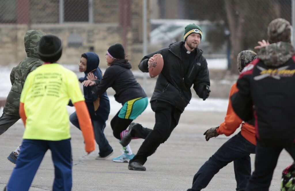 The Rev. Scott Jablonski plays football