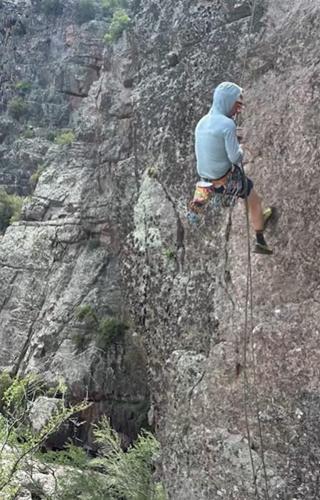 Climber Aaron Collins installs anchors along a new rock climbing route in Arizona. Collins is one of a few dozen volunteers working to expand Arizona's rock climbing opportunities.
