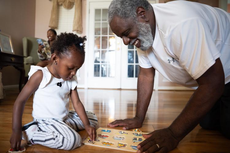 Michael Mays plays with his 2-year-old step-granddaughter, Kana-Leia Murray, at their home in Nashville on Tuesday, March 31, 2026.