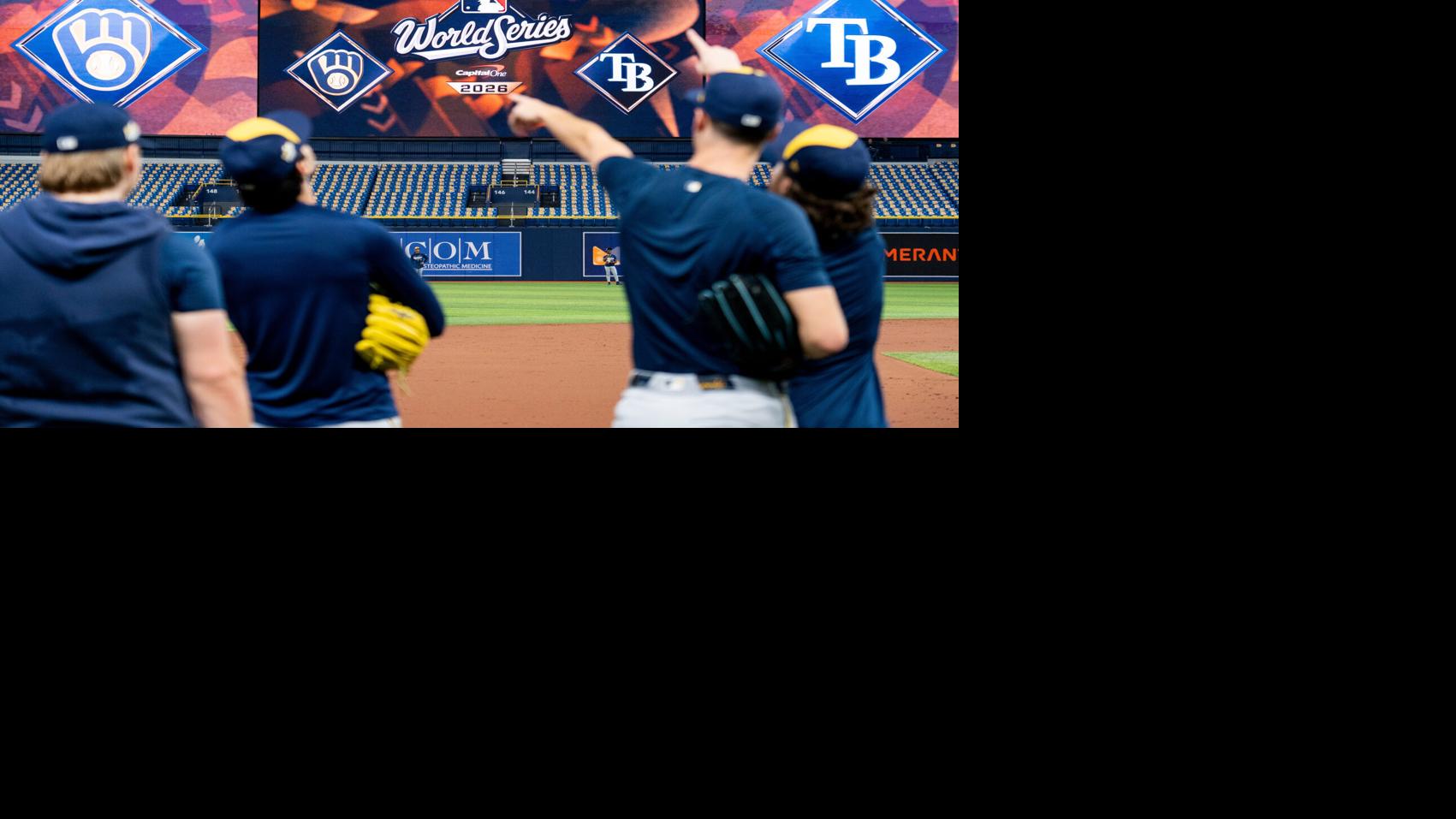 Milwaukee Brewers players point towards a fly ball during a workout and ...