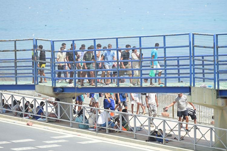 Migrants walk towards the border with Morocco to leave Spain, in Ceuta