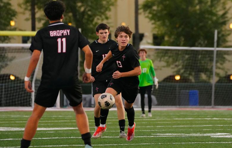 Brophy Prep midfielder Parker Dixon (13) dribbles up the pitch against Sunrise Mountain during a Open Division boys soccer state semifinal game in Phoenix, on Feb. 25, 2026.