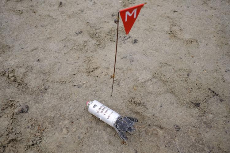 Russian forces left bombs, death and destruction around Kyiv. Now, a painstaking demining operation is underway