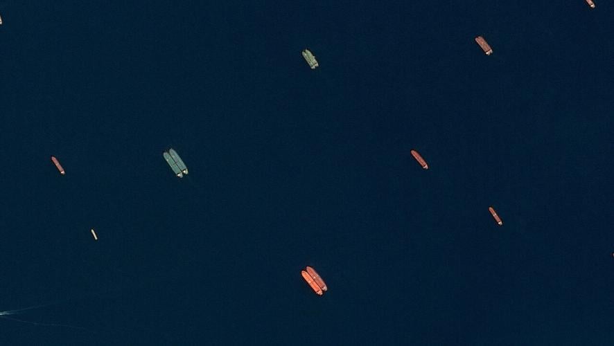 A satellite image of side-by-side ships at sea, off the coast of Sohar