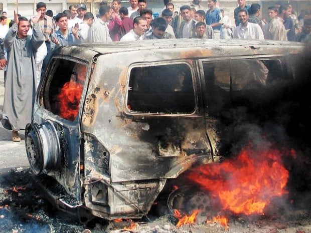 Mobs brutalize bodies of four U.S. contractors  