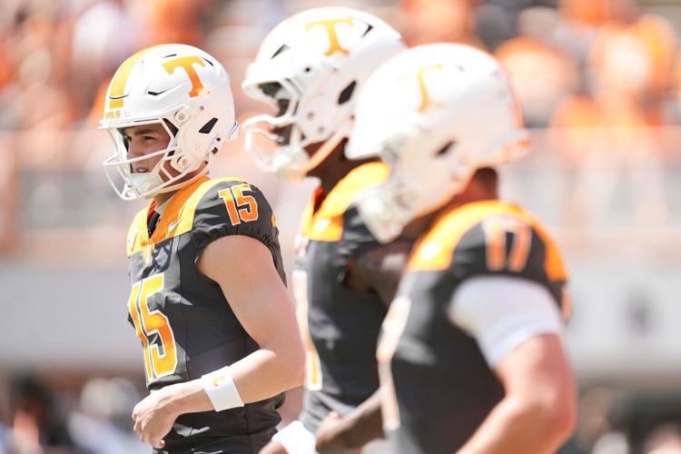 Tennessee quarterbacks including George MacIntyre (15), Faizon Brandon (11), and Ryan Staub (17), warm up before the Orange and White game at Neyland Stadium in Knoxville, Tennessee, April 11, 2026.