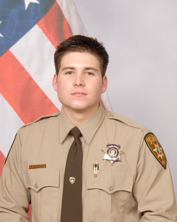 Tucson corrections officer accused in beating wins his job