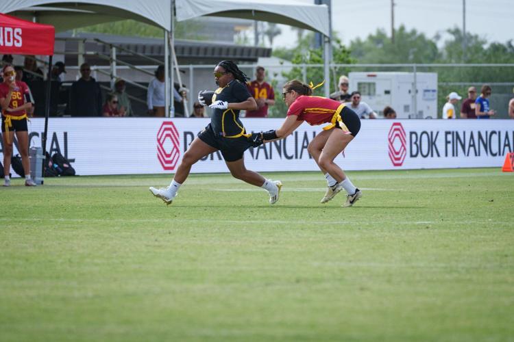 Sophia Smith (18) of the Arizona State Sun Devils runs with the ball as Jayden Bellemeur (13) goes for her flag as ASU plays USC