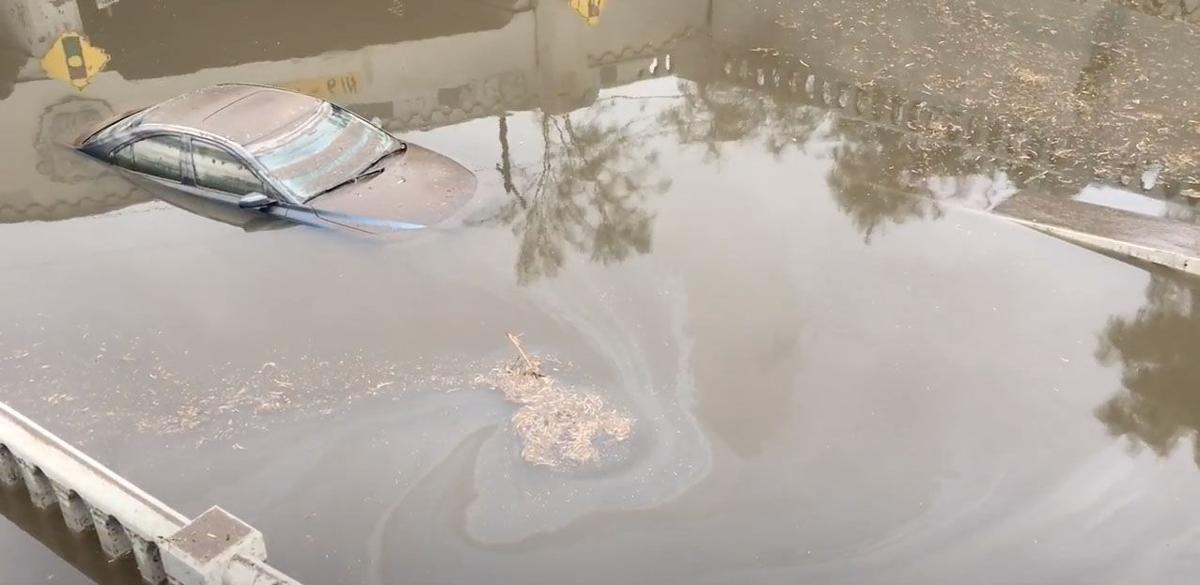 Car submerged in Stone Ave. underpass.