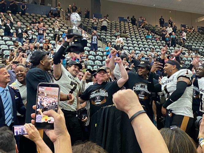 Rattlers quarterback Max Meylor and head coach Kevin Guy celebrate the IFL national championship on Sunday, Aug. 16, at Tucson Arena.