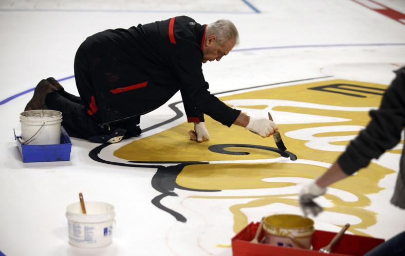 Jim Koehler, general manager of the United Center gets busy with the annual and traditional painting of the  Blackhawks logo on the United Center ice.