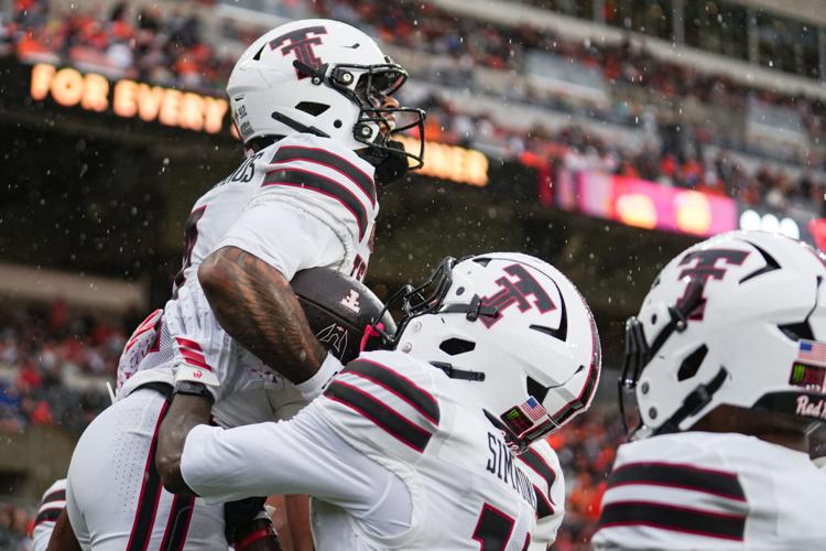Texas Tech's Thomas Castellanos, left, celebrates with his teammates after scoring a touchdown during an NCAA football game at