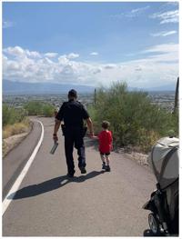 UAPD officer comforts scared 4-year-old as they walk down Tumamoc Hill