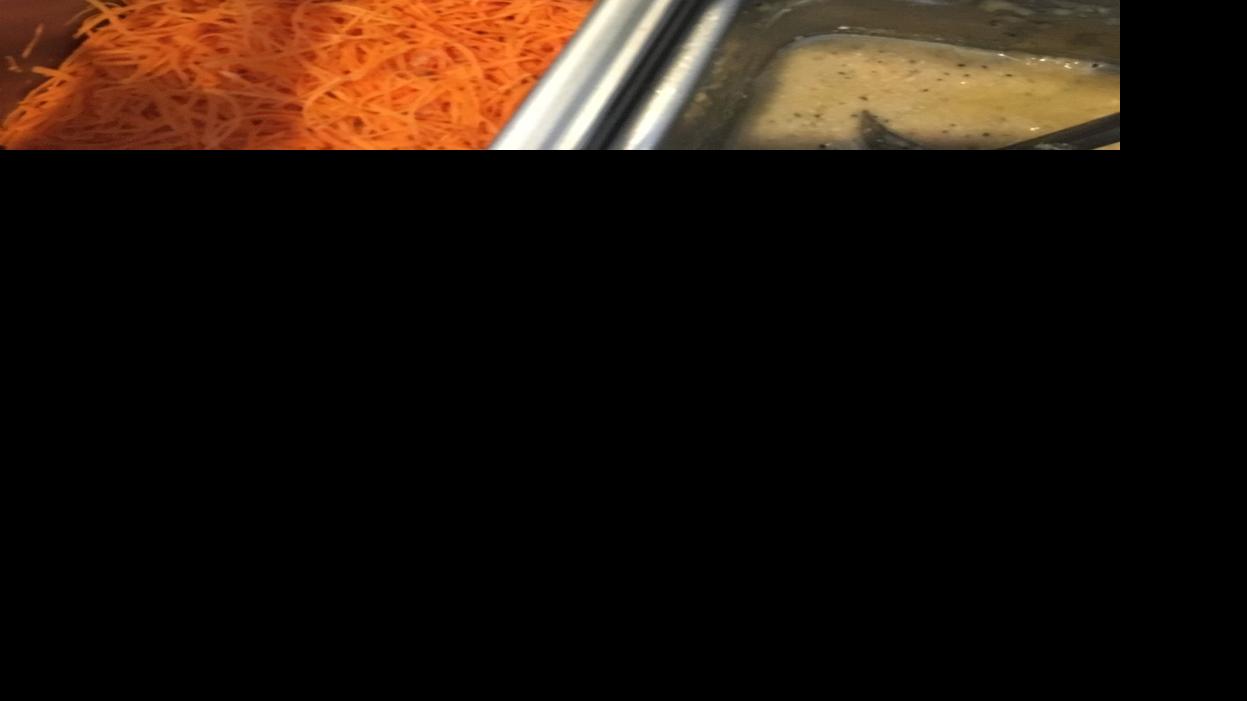 A food handler is prepping a seafood dish on april 4