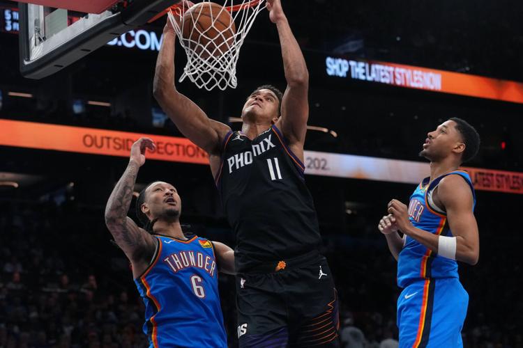 Phoenix Suns forward Oso Ighodaro (11) dunks the ball past Oklahoma City Thunder forward Jaylin Williams (6) during Game 3 of their playoff series at Mortgage Matchup Center in Phoenix on April 25, 2026.